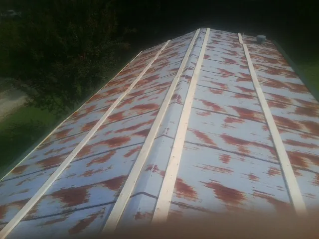 Rusted metal roof panels with new wood purlins before replacement — Storm Damage Roof Repair in Cleaton by Roofing Brothers